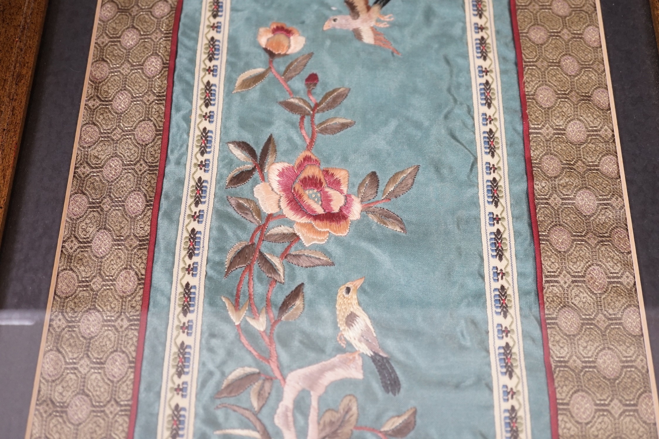 A pair of framed Chinese embroideries with bird and flower decoration, 34 x 14cm